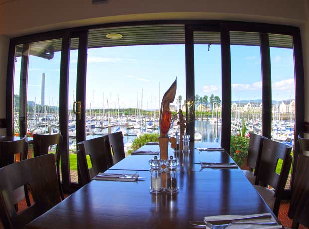 dining tables overlooking marina views with sliding doors