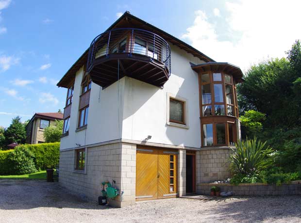 three storey building with garage and balcony