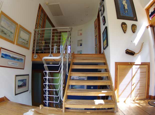 open tiered three levle stairway with bannister