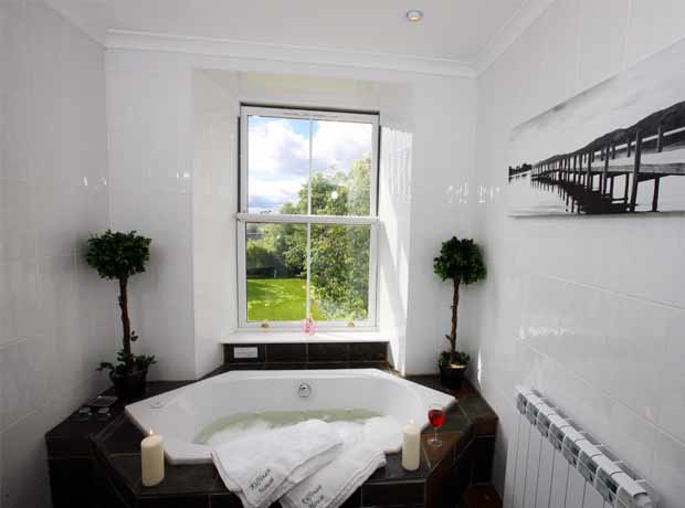 tiled bathroom with corner spa bath and power shower